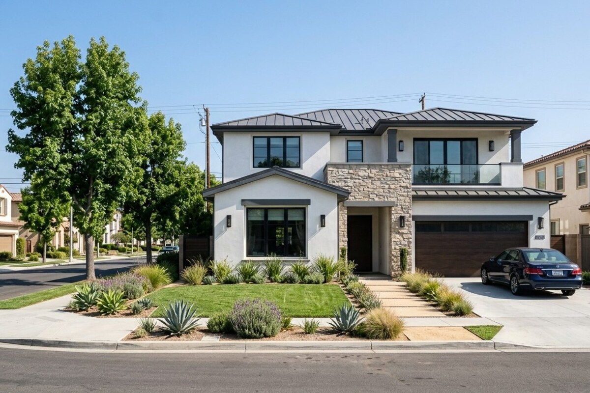 Modern two-story coastal California single-family home on a tree-lined residential street in Orange County, white