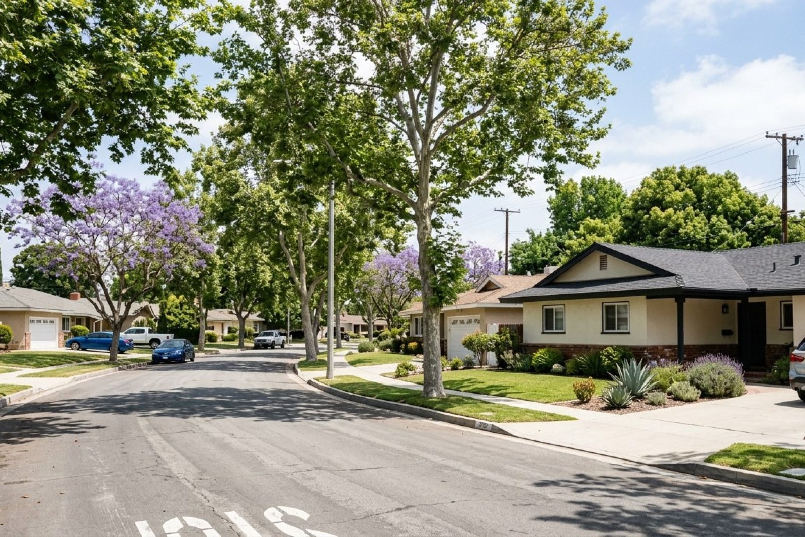 Photorealistic DSLR photograph of a tree-lined residential street in an inland Orange County neighborhood, mid-century ranch homes with stucco facades and two-car garages, mature sycamores casting dappled shade, no ocean visible, clear afternoon light, suburban California character