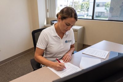 Property manager reviewing a residential lease at a Costa Mesa office desk